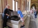 The guide lets Nicholas look in the baptismal font